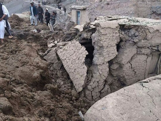 Afghan villagers gather at the site of a landslide at the Argo district in Badakhshan