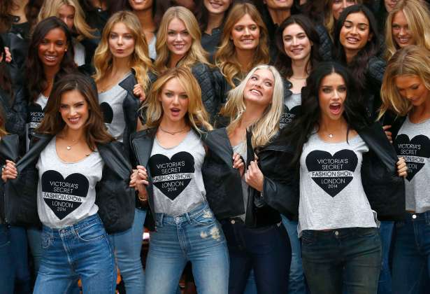 Models pose for a group photograph outside the Victoria's Secret shop on New Bond Street in central London