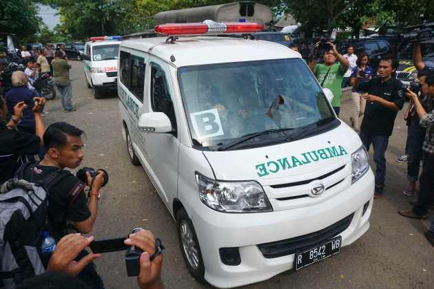 A convoy of ambulances carrying coffins make their way to Nusa Kambangan prison at Wijayapura quay