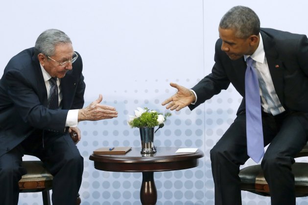 Obama reaches out to shake hands with Castro as they hold a bilateral meeting during the Summit of the Americas in Panama City, Panama