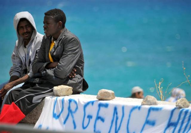 Varios inmigrantes esperan en la frontera ítalo-francesa en Ventimiglia, Italia, hoy 15 de junio de 2015, a que Francia desbloquee el acceso, después del endurecimiento por parte de París del control a personas indocumentadas que ha indignado al gobierno italiano. La inmigración será uno de los temas principales de la agenda de la cumbre europea los próximos 25 y 26 de junio en Bruselas. EFE/Luca Zennaro