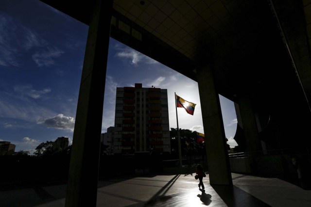 A woman walks out from the Venezuela's Supreme Court building in Caracas December 23, 2015. Venezuela's Congress on Wednesday named 13 justices to the Supreme Court in a manoeuvre critics slammed as a last-minute court-packing scheme by the Socialist Party in the final days before it loses control of the legislature in January. REUTERS/Carlos Garcia Rawlins