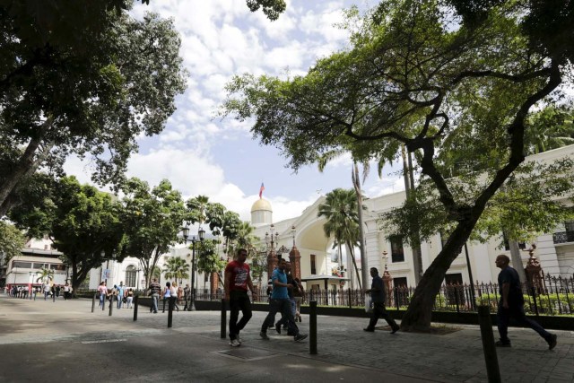 People walk past the National Assembly building during a parliamentary session in Caracas, January 4, 2016. REUTERS/Marco Bello