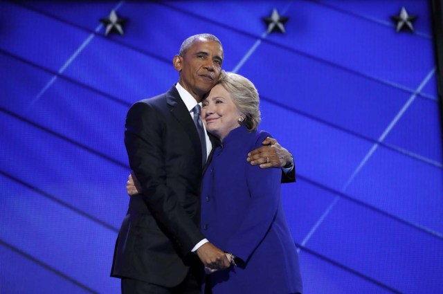 Democratic presidential nominee Hillary Clinton is embraced by U.S. President Barack Obama as she arrives onstage at the end of his speech on the third night of the 2016 Democratic National Convention in Philadelphia, Pennsylvania, U.S., July 27, 2016. REUTERS/Jim Young