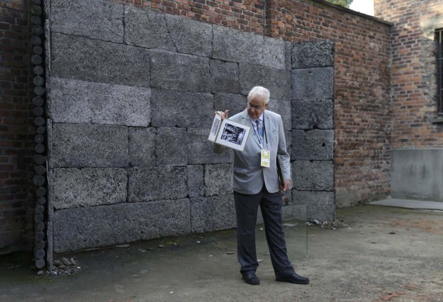 A survivor shows his picture in the book ahead of Pope Francis visit to the former Nazi German concentration and extermination camp Auschwitz-Birkenau in Oswiecim, Poland, July 29, 2016. REUTERS/David W Cerny