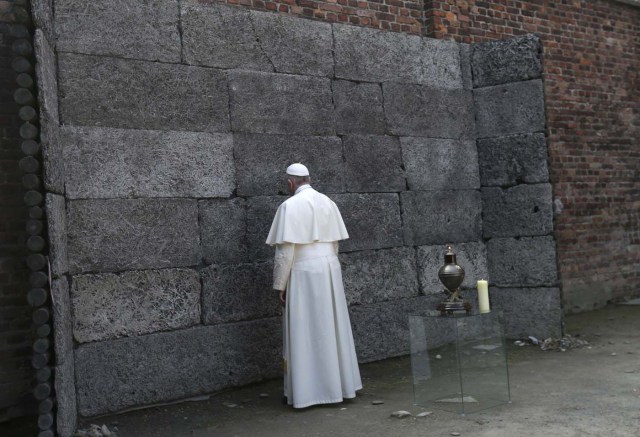 Pope Francis pays respects by the death wall in the former Nazi German concentration and extermination camp Auschwitz-Birkenau in Oswiecim, Poland, July 29, 2016. REUTERS/David W Cerny