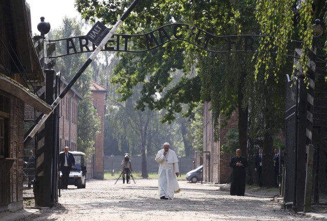 Pope Francis walks through a gate with the words "Arbeit macht frei" (Work sets you free) in the former Nazi German concentration and extermination camp Auschwitz-Birkenau in Oswiecim, Poland, July 29, 2016. REUTERS/Kacper Pempel