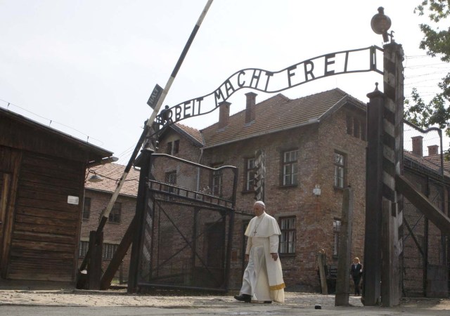 Pope Francis walks through a gate with the words "Arbeit macht frei" (Work sets you free) at the former Nazi German concentration and extermination camp Auschwitz-Birkenau in Oswiecim, Poland, July 29, 2016.  REUTERS/Kacper Pempel