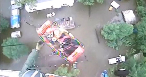 An aircrew from Coast Guard Air Station New Orleans rescues three people from a rooftop due to flooding in Baton Rouge, Louisiana, U.S., in this still image from video taken on August 13, 2016. Coast Guard Air Station New Orleans/Handout via REUTERS ATTENTION EDITORS - THIS IMAGE WAS PROVIDED BY A THIRD PARTY. EDITORIAL USE ONLY