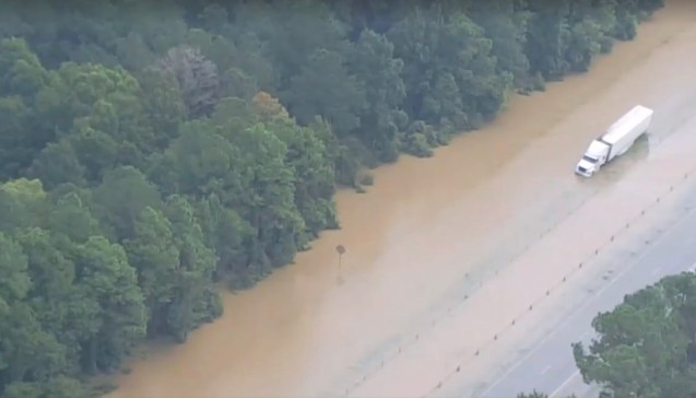 A truck sits stranded by floodwaters on Interstate 12 in Livingston Parish, Louisiana, in this still image from video taken August 14, 2016. Louisiana State Police/Handout via REUTERS ATTENTION EDITORS - THIS IMAGE WAS PROVIDED BY A THIRD PARTY. EDITORIAL USE ONLY
