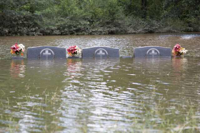 The floodwaters recede from Bethel United Methodist Cemetery in Greenwell Springs, Louisiana, U.S., August 14, 2016. REUTERS/Jeffrey Dubinsky