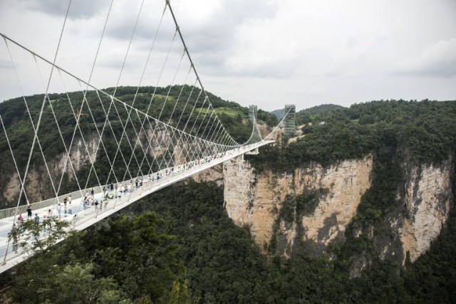 The world's highest and longest glass-bottomed bridge is seen above a valley in Zhangjiajie in China's Hunan Province on August 20, 2016. / AFP PHOTO / FRED DUFOUR