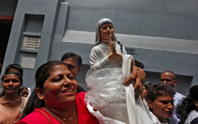 A woman holds a statuette of Mother Teresa outside the Missionaries of Charity building in Kolkata, India, as she was canonised during a ceremony held in the Vatican, September 4, 2016. REUTERS/Rupak De Chowdhuri