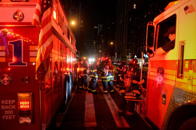 New York City firefighters stand near the site of an explosion in the Chelsea neighborhood of Manhattan, New York, U.S. September 17, 2016. REUTERS/Rashid Umar Abbasi