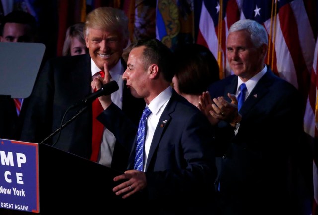 U.S. President-elect Donald Trump smiles as Republican National Committee Chairman Reince Priebus (C) speaks as Vice President-elect Mike Pence (R) looks on at Trump's election night rally in Manhattan, New York, U.S., November 9, 2016. REUTERS/Jonathan Ernst
