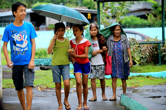 Residents evacuate to the Central Elementary School which was turned into an evacuation centre in Santo Domingo, Albay province on December 25, 2016 due to approaching Typhoon Nock-Ten. Thousands of residents were fleeing coastal and other hazardous areas in the eastern Philippines on December 25 as a powerful typhoon barrelled towards the disaster-prone archipelago. / AFP PHOTO / CHARISM SAYAT