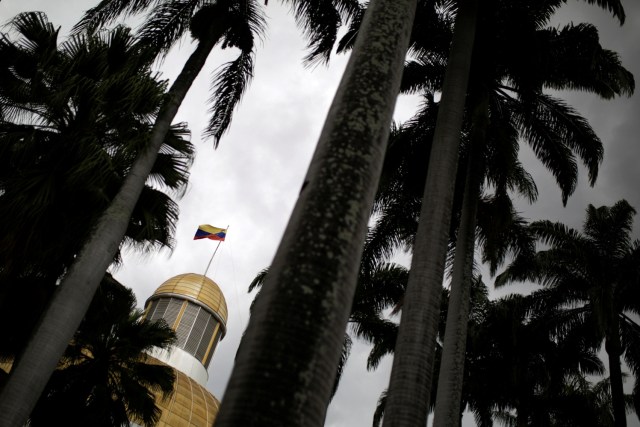The Venezuelan national flag is seen atop the building housing the National Assembly in Caracas, Venezuela January 9, 2017. REUTERS/Marco Bello