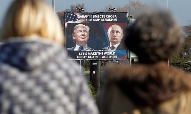 FILE PHOTO: A  billboard showing a pictures of US president-elect Donald Trump and Russian President Vladimir Putin is seen through pedestrians in Danilovgrad, Montenegro, November 16, 2016. REUTERS/Stevo Vasiljevic/File Photo