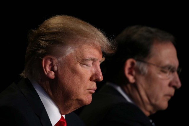 U.S. President Donald Trump prays during the National Prayer Breakfast event in Washington, U.S., February 2, 2017. REUTERS/Carlos Barria