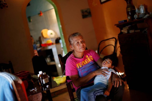 Isabel Buelvas takes a break while she gives a meal to her grandson Kaleth Heredia, 2, a neurological patient being treated with anticonvulsants, at their house in Caracas, Venezuela January 30, 2017. REUTERS/Carlos Garcia Rawlins   SEARCH "EPILEPSY CARACAS" FOR THIS STORY. SEARCH "WIDER IMAGE" FOR ALL STORIES.