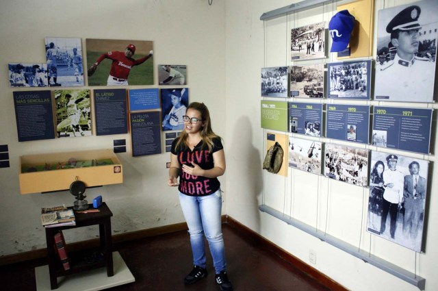 A tour guide talks to people next to pictures of Venezuela's late President Hugo Chavez in his childhood home in Sabaneta, Venezuela June 13, 2017. Picture taken June 13, 2017. REUTERS/Carlos Eduardo Ramirez
