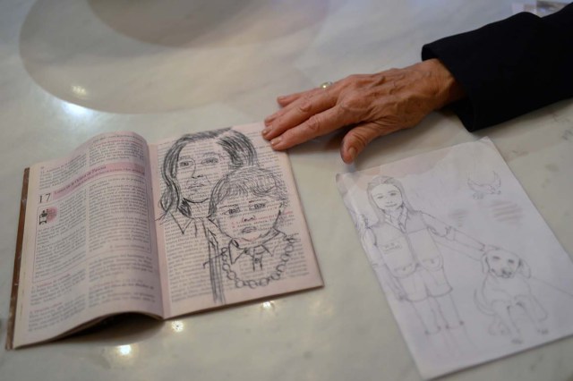 Antonieta Mendoza, mother of Venezuelan opposition leader Leopoldo Lopez, shows drawings made by her son depicting her and his grandson during an interview with AFP in Caracas on July 13, 2017. Lopez, a 46-year-old Harvard-educated politician, was imprisoned for more than three-and-a-half years for allegedly inciting violence by calling for anti-government protests. Today the most prominent opponent of Venezuela's President Nicolas Maduro, spends his first days of house arrest playing with his children, and gradually resumes political activity, holding meetings with international leaders regarding the country's severe crisis.  / AFP PHOTO / FEDERICO PARRA