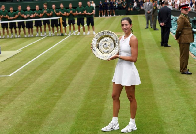 Tennis - Wimbledon - London, Britain - July 15, 2017 Spain’s Garbine Muguruza poses with the trophy as she celebrates winning the final against Venus Williams of the U.S. REUTERS/Tony O'Brien