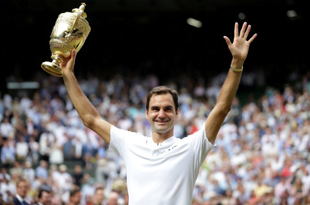 Tennis - Wimbledon - London, Britain - July 16, 2017 Switzerland’s Roger Federer poses with the trophy as he celebrates winning the final against Croatia’s Marin Cilic REUTERS/Daniel Leal-Olivas/Pool TPX IMAGES OF THE DAY