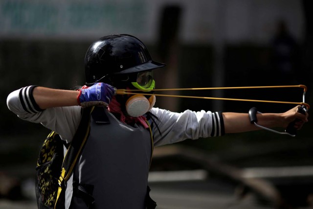 A demonstrator uses a slingshot during a strike called to protest against Venezuelan President Nicolas Maduro's government in Caracas, Venezuela July 26, 2017. REUTERS/Marco Bello