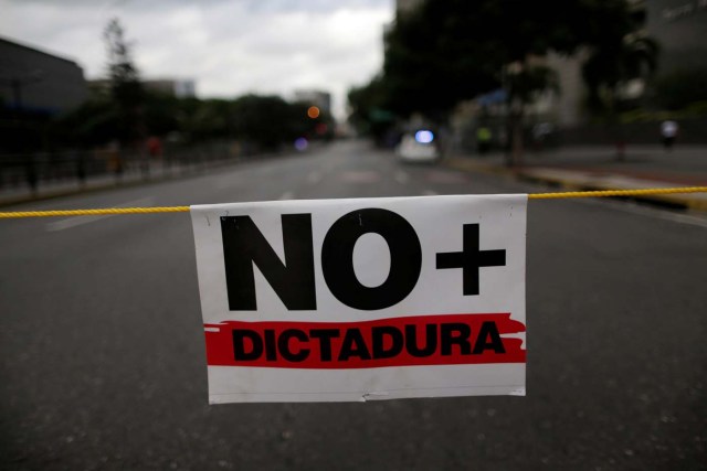 A placard that reads "No more dictatorship" is seen during a strike called to protest against Venezuelan President Nicolas Maduro's government in Caracas, Venezuela July 26, 2017. REUTERS/Ueslei Marcelino