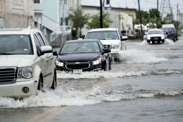 Vehicles drive through a flooded street as the effects of Hurricane Harvey are seen August 26, 2017 in Galveston, Texas. Hurricane Harvey left a trail of devastation Saturday after the most powerful storm to hit the US mainland in over a decade slammed into Texas, destroying homes, severing power supplies and forcing tens of thousands of residents to flee. / AFP PHOTO / Brendan Smialowski / ?The erroneous mention[s] appearing in the metadata of this photo by Brendan Smialowski has been modified in AFP systems in the following manner: [Hurricane Harvey] instead of [Hurricane Henry]. Please immediately remove the erroneous mention[s] from all your online services and delete it from your servers. If you have been authorized by AFP to distribute it to third parties, please ensure that the same actions are carried out by them. Failure to promptly comply with these instructions will entail liability on your part for any continued or post notification usage. Therefore we thank you very much for all your attention and prompt action. We are sorry for the inconvenience this notification may cause and remain at your disposal for any further information you may require.?