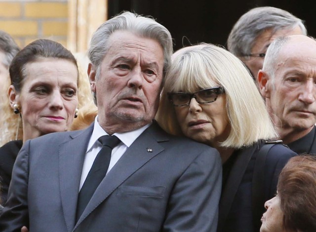 (FILES) This file photo taken on September 20, 2012 shows French actor Alain Delon (L) and French actress Mireille Darc (R) attending the funeral ceremony of late French actor and stage director Pierre Mondy outside the Saint-Honore d'Eylau church, in Paris. Mireille Darc died at age 79 on August 28, 2017, according to her family. / AFP PHOTO / PATRICK KOVARIK