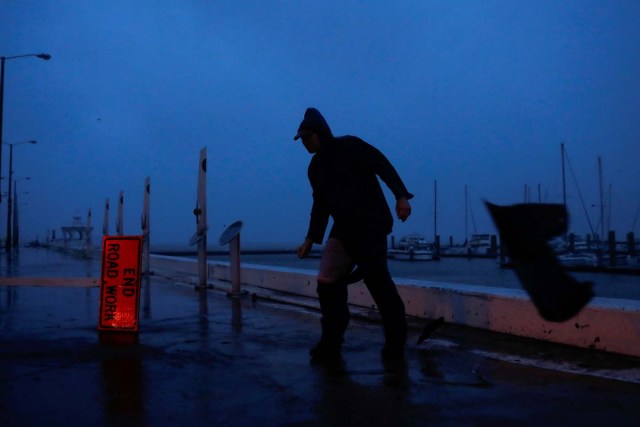 Debris flies past as Stewart Adams, of San Marcos, Texas, balances himself from a gust of wind from Hurricane Harvey along the boardwalk in Corpus Christi, Texas, U.S. August 25, 2017. REUTERS/Adrees Latif TPX IMAGES OF THE DAY