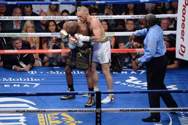 Aug 26, 2017; Las Vegas, NV, USA; Floyd Mayweather Jr. (black trunks) and Conor McGregor (white trunks) box during the third round of their boxing match at T-Mobile Arena. Mayweather won via tenth round TKO. Mandatory Credit: Joe Camporeale-USA TODAY Sports