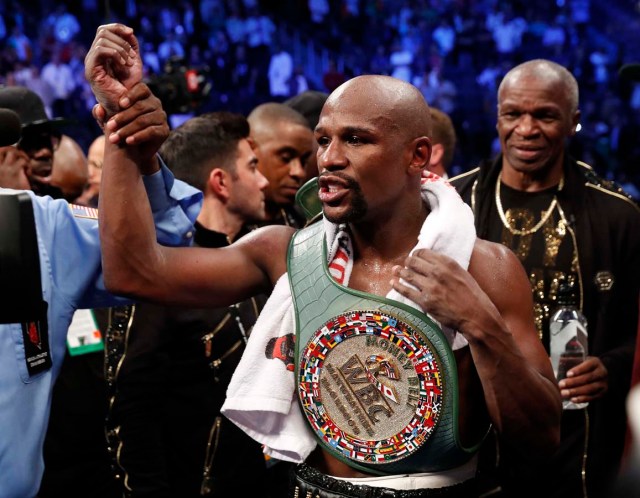 Boxing - Floyd Mayweather Jr. vs Conor McGregor - Las Vegas, USA - August 26, 2017 Floyd Mayweather Jr. celebrates with the belt after winning the fight REUTERS/Steve Marcus