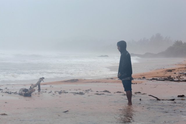 A man stands on the beach as Hurricane Irma slammed across islands in the northern Caribbean on Wednesday, in Luquillo, Puerto Rico September 6, 2017.  REUTERS/Alvin Baez