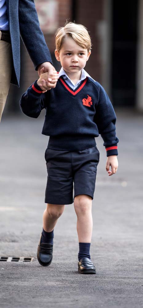 Prince George holds his father Britain's Prince William's hand as he arrives on his first day of school at Thomas's school in Battersea, London, September 7, 2017. REUTERS/Richard Pohle/Pool