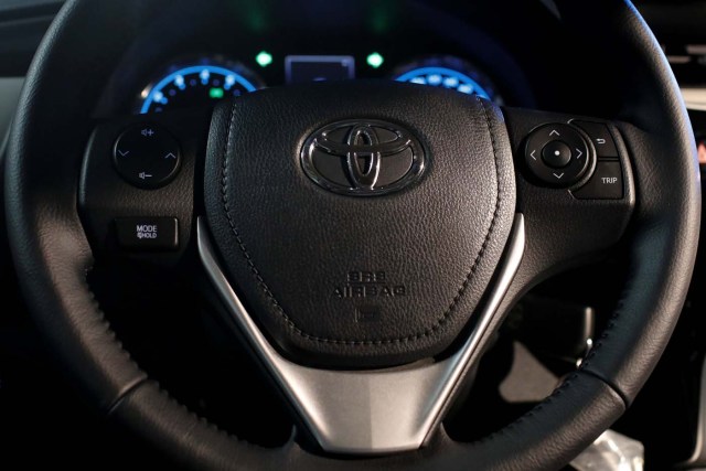 The logo of Toyota Motor Corp. is seen on a steering wheel of the company's Corolla car in Caracas, Venezuela October 25, 2017. REUTERS/Marco Bello