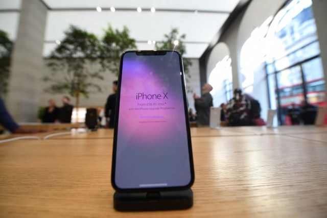 An Apple iPhone X smartphone is seen at Apple's Regent Street store in central London on November 3, 2017 after it opened for the first sales of the new smartphone. Apple's flagship iPhone X hit stores on November 3, as the world's most valuable company predicted bumper sales despite the handset's eye-watering price tag and celebrated a surge in profits. The device features facial recognition, cordless charging and an edge-to-edge screen made of organic light-emitting diodes used in high-end televisions. It marks the 10th anniversary of the first iPhone release and is released in about 50 markets around the world. / AFP PHOTO / Chris J Ratcliffe