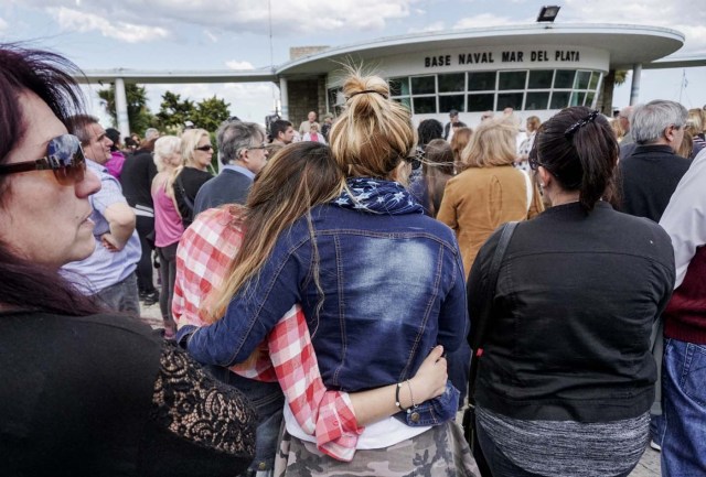 People pray outside Argentina's Navy base in Mar del Plata, on the Atlantic coast south of Buenos Aires, on Novembe 22, 2017, while the search for the missing ARA San Juan submarine keeps going on. The clock ticked down Wednesday on hopes of finding alive the 44 crew members of an Argentine submarine missing for a week despite a massive search of surface and seabed, amid fears their oxygen had run out. The ARA San Juan would have had enough oxygen for its crew to survive underwater in the South Atlantic for seven days since its last contact, according to officials. / AFP PHOTO / EITAN ABRAMOVICH