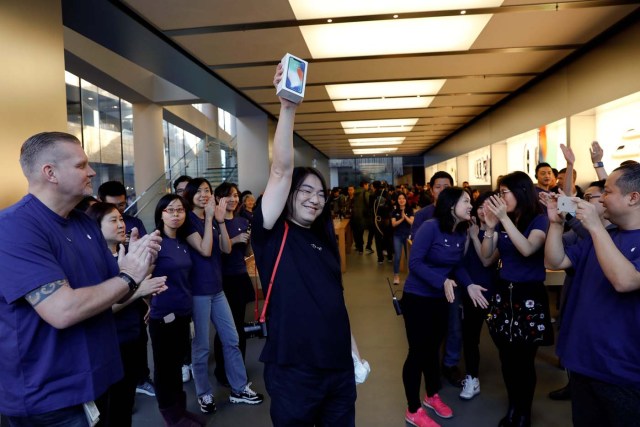 One of the first customers shows his new iPhone X after buying it at an Apple Store in Beijing, China November 3, 2017. REUTERS/Damir Sagolj