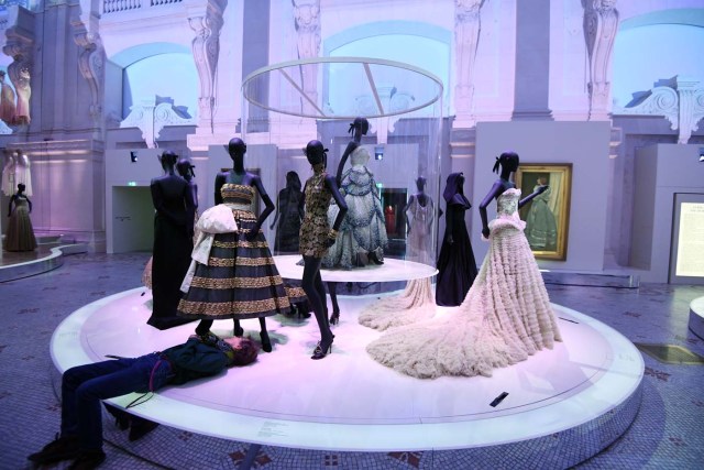 (FILES) This file picture taken on July 3, 2017 shows a man adjusting a dress prior to the opening of the Dior exhibition that celebrates the seventieth anniversary of the Christian Dior fashion house, at the Museum of Decorative Arts (Musee des Arts Decoratifs) in Paris. 708 000 people visited the exhibition dedicated to Christian Dior from July 5, 2017 to January 7, 2018 in Paris. / AFP PHOTO / ALAIN JOCARD