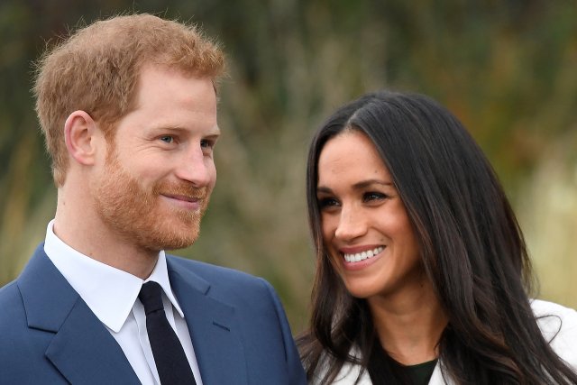 FILE PHOTO: Britain's Prince Harry poses with Meghan Markle in the Sunken Garden of Kensington Palace in London, Britain, November 27, 2017. REUTERS/Toby Melville/File Photo