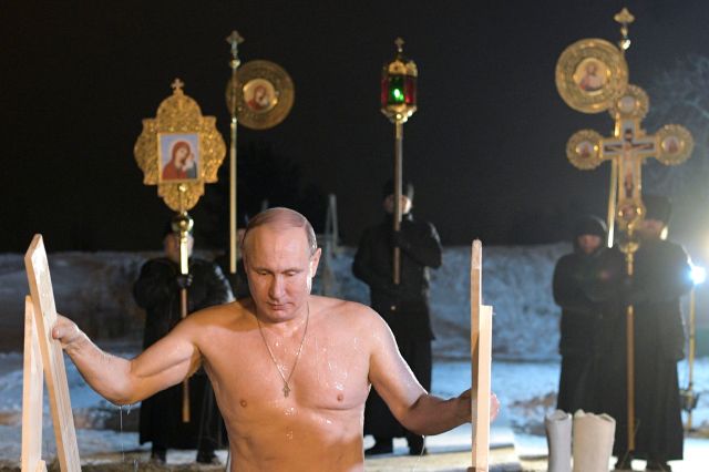 Russian President Vladimir Putin walks out of a hole in the ice after taking a dip in the freezing waters of Lake Seliger during Orthodox Epiphany celebrations in Tver region, Russia January 19, 2018. Sputnik/Alexei Druzhinin/Kremlin via REUTERS ATTENTION EDITORS - THIS IMAGE WAS PROVIDED BY A THIRD PARTY.
