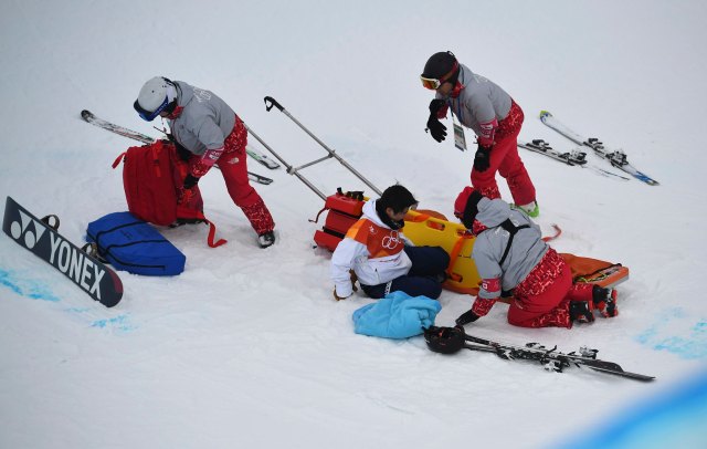 Snowboarding - Pyeongchang 2018 Winter Olympics - Men's Halfpipe Finals - Phoenix Snow Park – Pyeongchang, South Korea – February 14, 2018 - Yuto Totsuka of Japan is assisted after a crash. REUTERS/Dylan Martinez