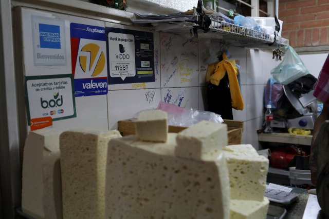 Information for Vippo app and other methods of payment is seen at a cheese and dairy products stall at Chacao Municipal Market in Caracas, Venezuela January 19, 2018. Picture taken January 19, 2018. REUTERS/Marco Bello