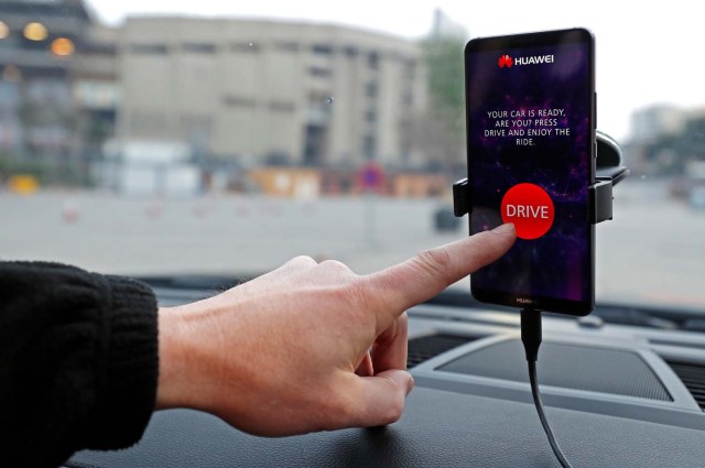An engineer points to a Huawei Mate 10 Pro mobile used to control a driverless car during the Mobile World Congress in Barcelona, Spain February 26, 2018. REUTERS/Yves Herman