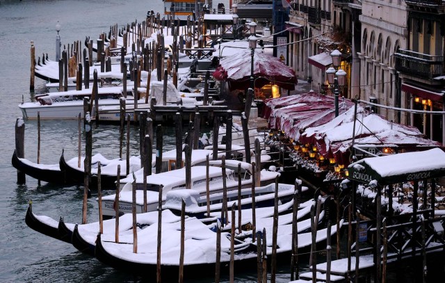 Snow covered gondola's are seen on Canal Grande (Grand Canal) in Venice lagoon, Italy, February 28, 2018. REUTERS/Manuel Silvestri