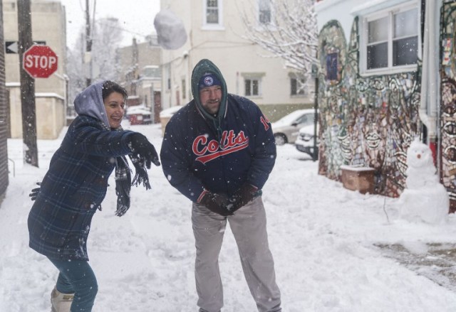 PHILADELPHIA, PA - MARCH 21: Sandy Racowski, left, and her husband Ken Rocowski, right, have a snowball fight with their kids on March 21, 2018 in Philadelphia, Pennsylvania. The fourth nor'easter in three weeks has forced school closures and flight cancellations on the second day of spring.   Jessica Kourkounis/Getty Images/AFP