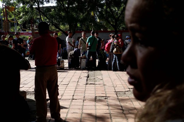 People traveling by bus from Caracas to Ecuador wait in line to stamp their passports at the migration control office in San Antonio del Tachira, Venezuela, November 8, 2017. After more than twelve hours traveling, crossing into Colombia was for many on the bus the first time they had left Venezuela. When they arrived at the migration office, it was temporarily closed because the computers were down. Travelers had to wait in line about three hours to get their documents stamped. REUTERS/Carlos Garcia Rawlins SEARCH "RAWLINS BUS" FOR THIS STORY. SEARCH "WIDER IMAGE" FOR ALL STORIES.